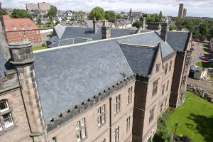 A slate-covered building roof highlighting the structure's historical charm and design.