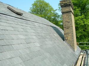 Slate shingled roof showcasing a classic architectural design on a series of buildings.