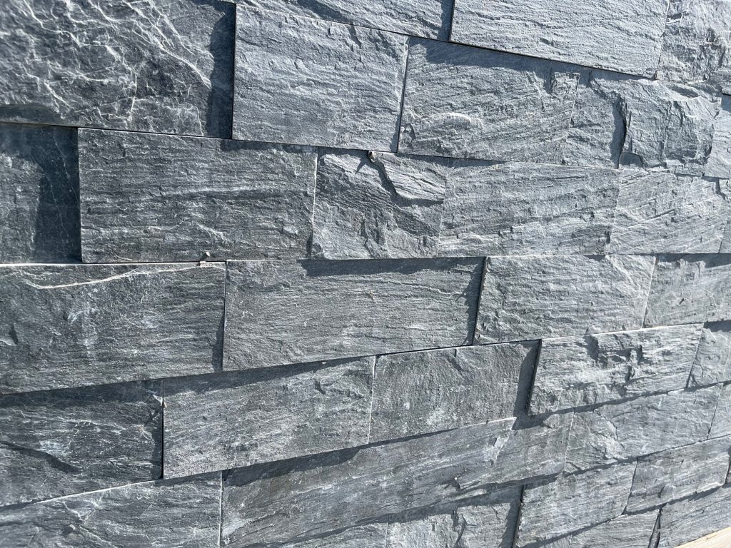 Riverstone cladding on a low wall