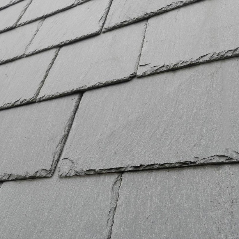 Close-up of a black slate roof showcasing the texture and arrangement of the slate tiles.