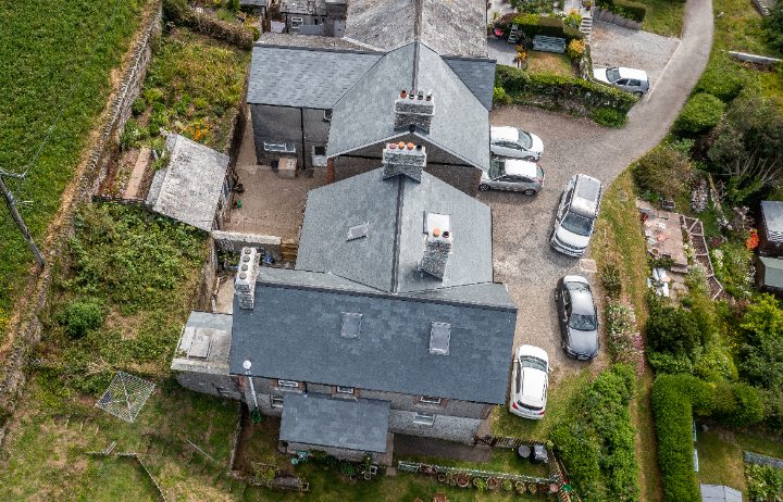 High-angle view of the refurbished cottages and surrounding gardens, illustrating how the Riverstone slate blends into the conservation area.