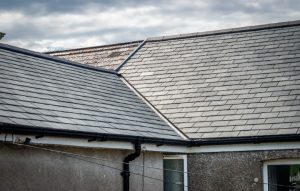 Detailed shot of a roof valley where two pitches meet, showcasing the installation and authentic texture of Riverstone slate