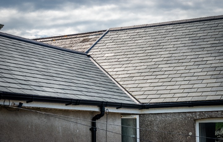 Detailed shot of a roof valley where two pitches meet, showcasing the installation and authentic texture of Riverstone slate