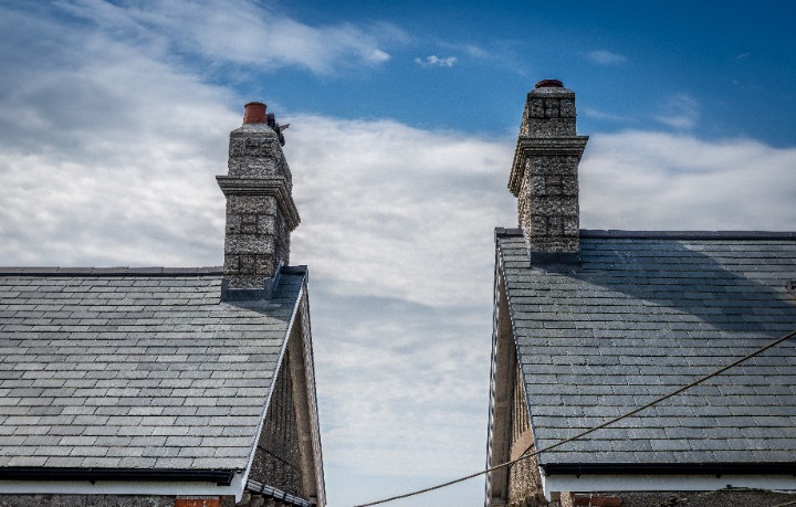 View of two cottage gables against a blue sky, demonstrating the uniform and premium appearance of Riverstone slate.