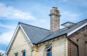 Side profile of cottage roof featuring an integrated skylight, showing how Riverstone slate maintains a traditional aesthetic