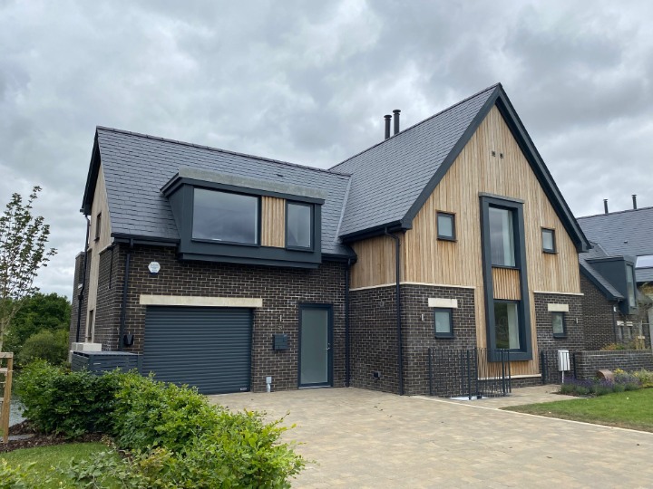 SSQ Del Prado slate roofing complementing timber cladding and contemporary architectural detailing